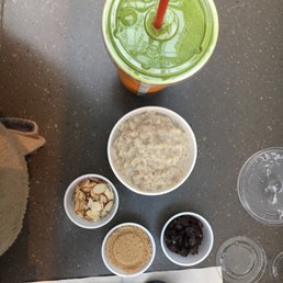 Small oatmeal with brown sugar, toasted almonds, and raisins as toppings. Kale-Spinach smoothie with a yogurt base  so good!