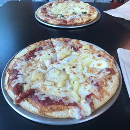 two pizzas on a table