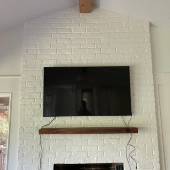 Handy Art - TV mounting on brick above a fireplace - Handyman Near Me