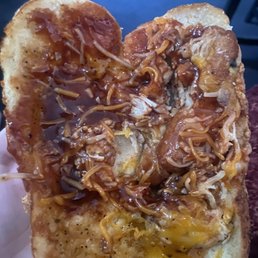 a hand holding a heart shaped pizza