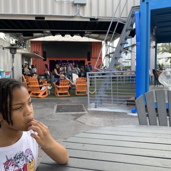 Boxi Park - Boxi Park looking at the stage and an angel enjoying food. - Bars Near Me - Orlando, Florida Boxi Park - Boxi Park looking at the stage and an angel enjoying food. - Bars Near Me - Orlando, Florida