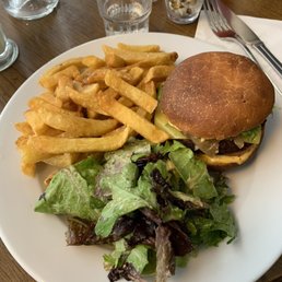 Cheeseburger with salad and fries. Cheeseburger with salad and fries.