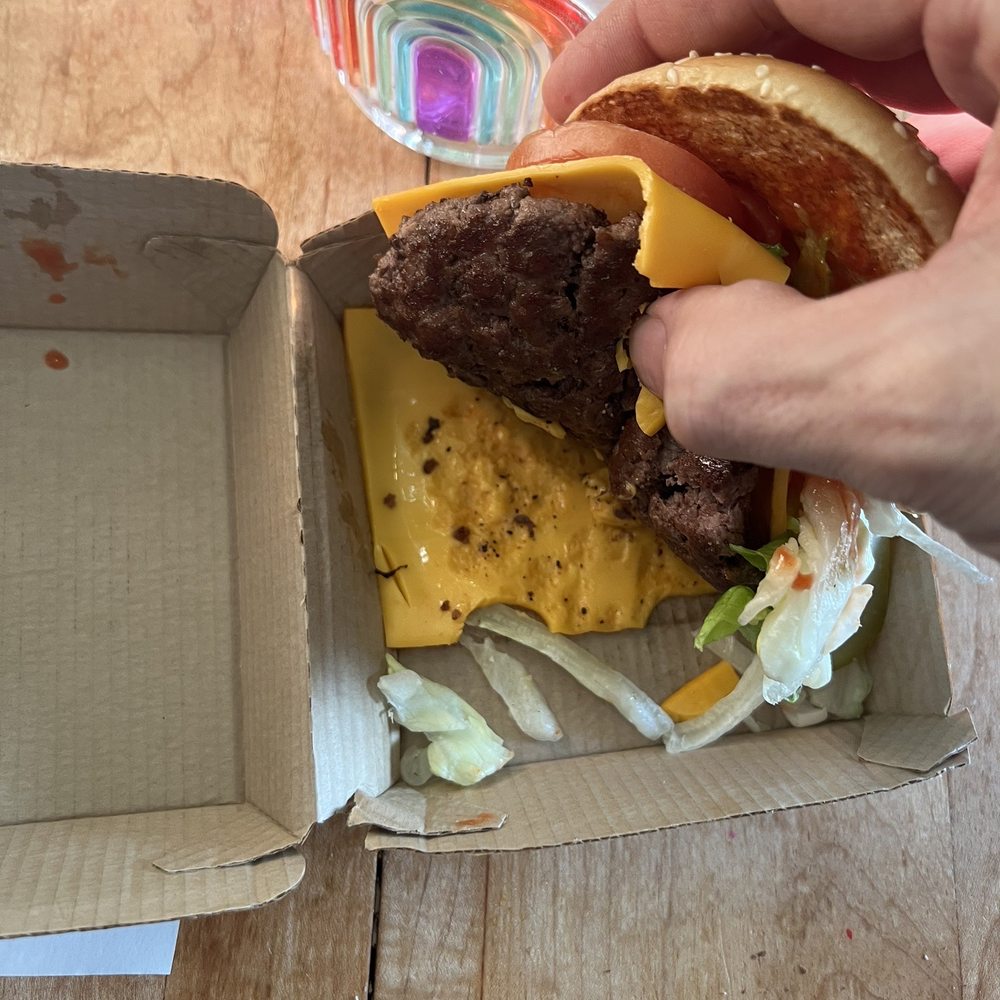 Quarter Pounder with Cheese Deluxe with no bottom bun. Quarter Pounder with Cheese Deluxe with no bottom bun.