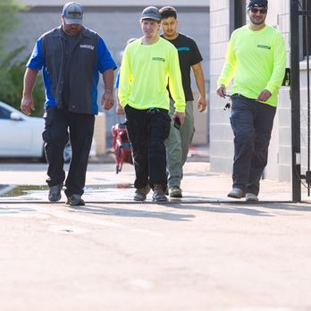 Wyman Plumbing & Mechanical - Plumbing service crew walking outdoors near a shop building in high-visibility safety shirts and workwear. - Plumbing Near Me - Phoenix, Arizona Wyman Plumbing & Mechanical - Plumbing service crew walking outdoors near a shop building in high-visibility safety shirts and workwear. - Plumbing Near Me - Phoenix, Arizona