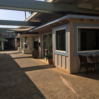 Anuenue Cafe - We were seated to the right of the empty store in the front of the picture, with Anuenue being the second store in the back..kind of weird. - Cafes Near Me - Koloa, Hawaii