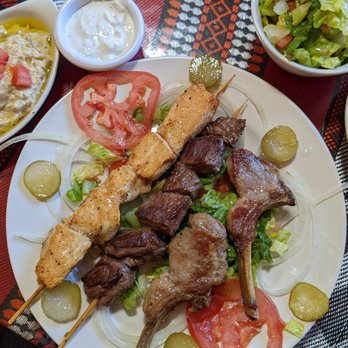 Arabian Nights Bistro - Grill platter with chicken shish kabob, beef, shish, kabob, lamb, hummus, baba ganoush, tahini sauce, and salad. Also included a pita - Mediterranean Near Me - Albuquerque, New Mexico