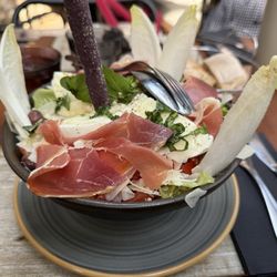 Deli' - Mozzarella salad with tomatoes, endive, prosciutto and a giant purple breadstick