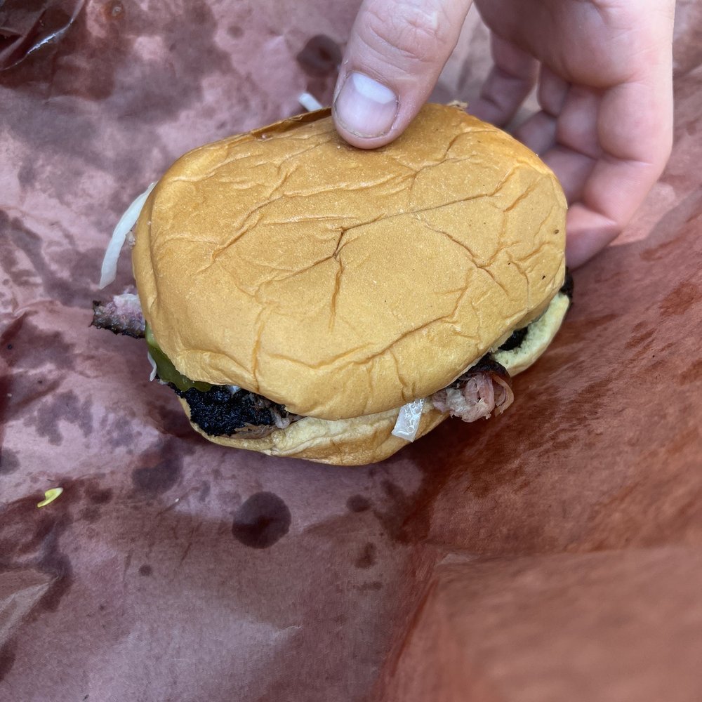 County Road Provisions - a hand holding a hamburger - Food Trucks Near Me - St. Augustine, Florida County Road Provisions - a hand holding a hamburger - Food Trucks Near Me - St. Augustine, Florida