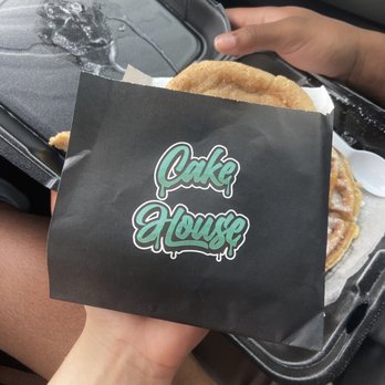 Cake House - a person holding a piece of cake - Desserts Near Me - Texarkana, Texas