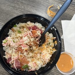 Salmon, tuna, white rice, house sauce with a side of spicy creamy, 2 scoops of crab, green and crispy onion Salmon, tuna, white rice, house sauce with a side of spicy creamy, 2 scoops of crab, green and crispy onion