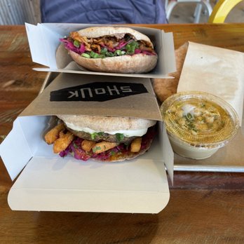 Shouk - Top: BBQ Jack Pita Bottom: Eggplant Burger (special) Side of Hummus February 12, 2022 - Vegan Near Me - Rockville, Maryland Shouk - Top: BBQ Jack Pita Bottom: Eggplant Burger (special) Side of Hummus February 12, 2022 - Vegan Near Me - Rockville, Maryland
