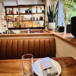 Take Care - Lovely wood tables & leather seating with plants