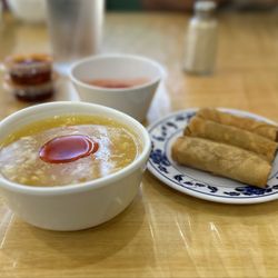 Lucky China - Egg flower soup with chili oil on top, beside it is spring rolls.