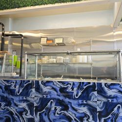 Reggae Cuisine - Steam table area and display with Jamaican patties. Good amount of choices. More options available from the kitchen.