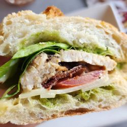 Le Cafe Du Val - Chicken Sandwich Dijon mustard chicken, mixed greens, tomatoes, bacon, swiss cheese, basil sauce on baguette