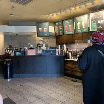 Starbucks - a man and a woman standing in a coffee shop - Coffee & Tea Near Me - Sevierville, Tennessee Starbucks - a man and a woman standing in a coffee shop - Coffee & Tea Near Me - Sevierville, Tennessee