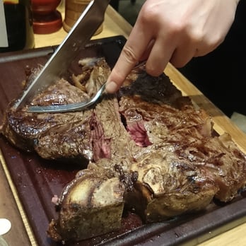 Tramshed - Carving up the 1kg Porterhouse at your table. - British Near Me - London, XGL