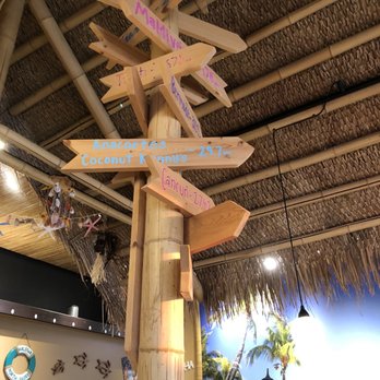 Coconut Kenny's Pizza - Lynden - a wooden pole with directional signs - Pizza Near Me - Lynden, Washington