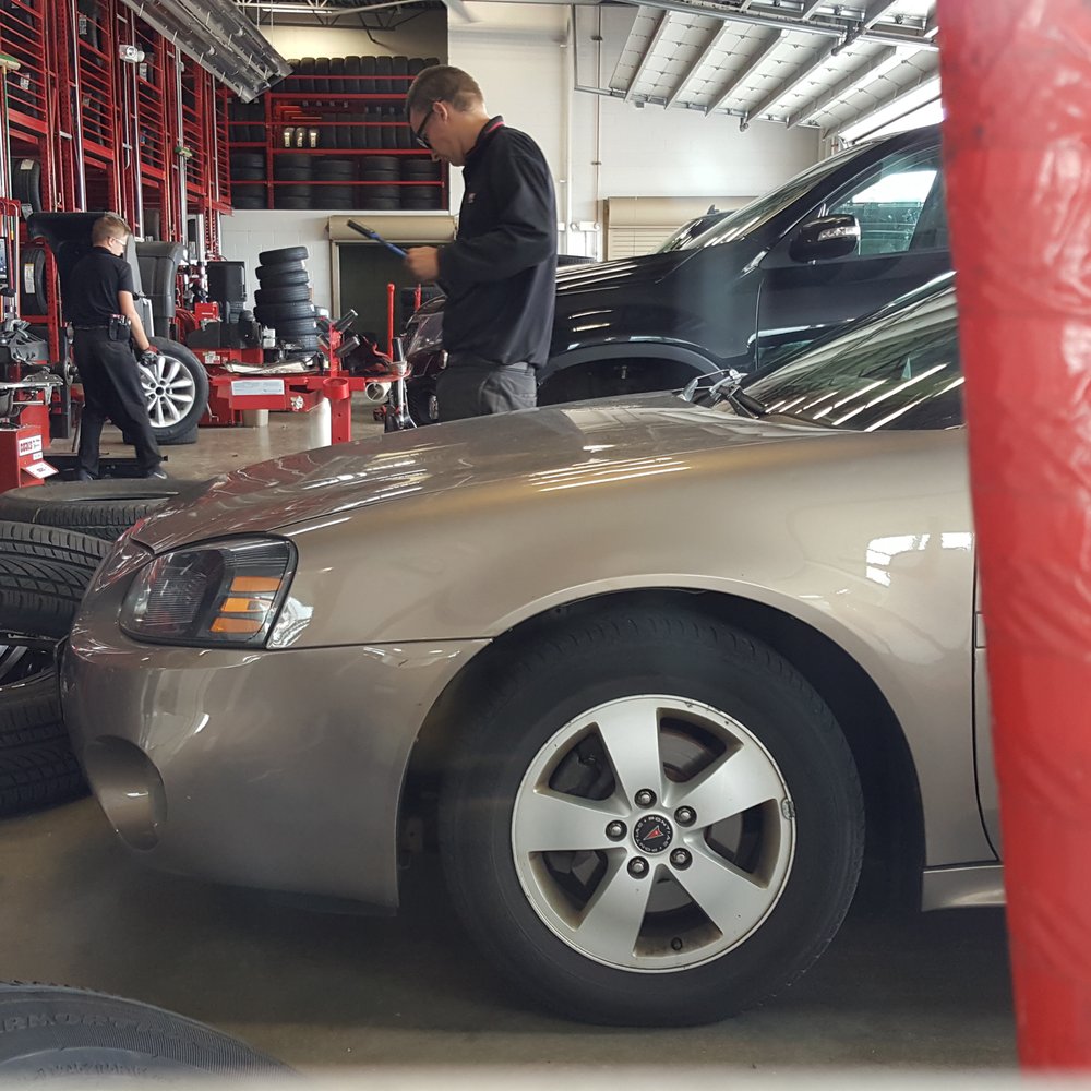 Discount Tire - Service bays. The guy in the back holding the wheel is mine. - Wheel & Rim Repair Near Me - Woodbury, Minnesota