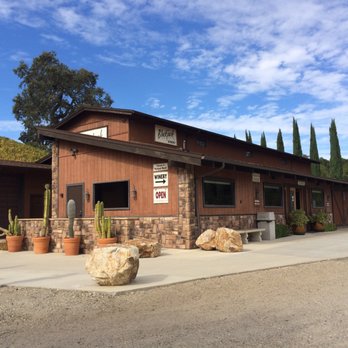 Blackjack Ranch - a man and a woman walking in front of a building - Wineries Near Me - Solvang, California Blackjack Ranch - a man and a woman walking in front of a building - Wineries Near Me - Solvang, California