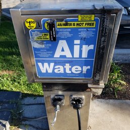 an air water dispenser on a sidewalk an air water dispenser on a sidewalk