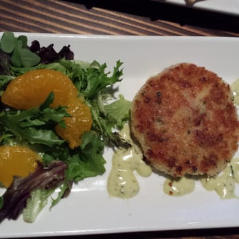 Twisted Fish Steakhouse - Dungeness Crab Cake with lemon tarragon and house greens - Steakhouses Near Me - Seaside, Oregon Twisted Fish Steakhouse - Dungeness Crab Cake with lemon tarragon and house greens - Steakhouses Near Me - Seaside, Oregon