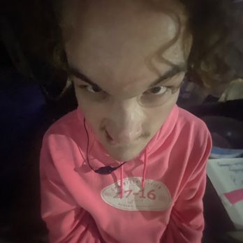 17-16 - a young girl with a pink shirt and earphones - Bars Near Me - Auburn, Alabama
