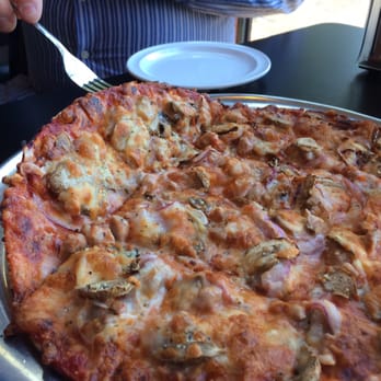 Imo's Pizza - Pizza cut into squares, four inies and several outies. - Pizza Near Me - Saint Louis, Missouri Imo's Pizza - Pizza cut into squares, four inies and several outies. - Pizza Near Me - Saint Louis, Missouri