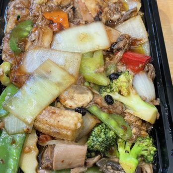 Lucky Wok - 30. Hunan Duck - A black plastic takeout container holds stir-fried vegetables and meat, including broccoli, bell peppers, onions, and tofu, with a savory sauce. - Chinese Near Me - Albuquerque, New Mexico