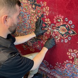 Fiber Specialties - Our rug specialist trimming and securing loose fibers, Part of our finish inspection