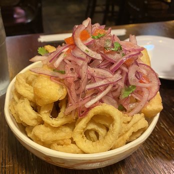 Picca Pollo A La Brasa - Calamari with yucca topped with pickled red onion - Peruvian Near Me - Germantown, Maryland Picca Pollo A La Brasa - Calamari with yucca topped with pickled red onion - Peruvian Near Me - Germantown, Maryland