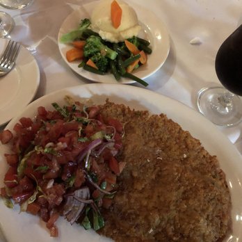 Riviera Ristorante - Costoletta Milanese Capricciosa  breaded veal cutlet topped with tomato,onions, basil, oil and balsamic vinegar As big as the dinner plate! - Italian Near Me - Whitestone, New York