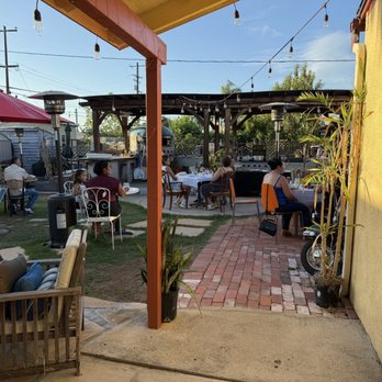 Marcello Pizza Napoli - The view into the dining space as you walk around the backside of the house. - Caterers Near Me Marcello Pizza Napoli - The view into the dining space as you walk around the backside of the house. - Caterers Near Me