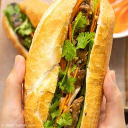 a person holding a sandwich a person holding a sandwich