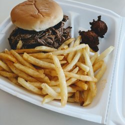 Poor Piggy's - Brisket Sandwich with the seasoned shoo string fries on the side..and some fun hush puppies!