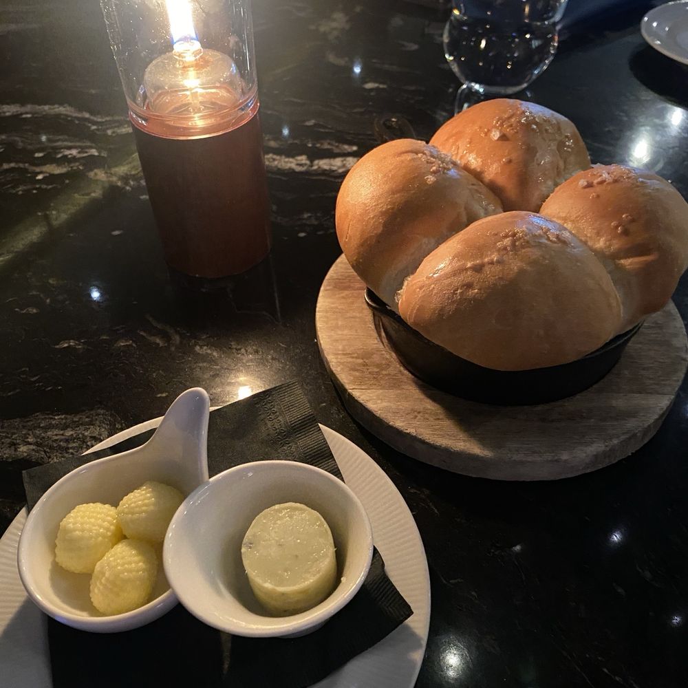Atlas Steak + Fish - The soft bread bun with goat cheese butter and regular butter - Steakhouses Near Me - Burnaby, British Columbia