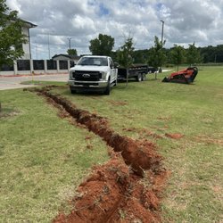 Yard Worx and Materials - Taking the old dirt away from the French drain ditch is important to the process.