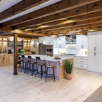 Design Craft Kitchen & Bath - Franklin, TN kitchen remodel featuring warm white cabinetry, a large island with seating, warm wood accent, and rustic exposed wood ceiling. - Kitchen & Bath Near Me - Brentwood, Tennessee Design Craft Kitchen & Bath - Franklin, TN kitchen remodel featuring warm white cabinetry, a large island with seating, warm wood accent, and rustic exposed wood ceiling. - Kitchen & Bath Near Me - Brentwood, Tennessee
