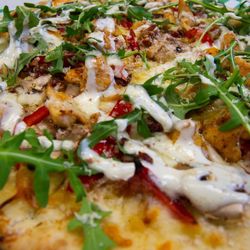 Scotty's Pub on the Bay - The Lobbyist - Starts with a Garlic Sauce, &  Grilled Chicken, Mushrooms, Bacon, Roasted Red Peppers,  Arugula, Walnuts, & Ranch Dressing