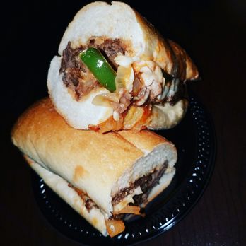 Magdy's - a beef sandwich cut in half - Food Trucks Near Me Magdy's - a beef sandwich cut in half - Food Trucks Near Me