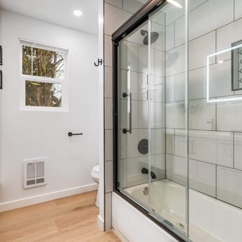 Vasa Construction - a bathroom with a shower, sink, and toilet - Roofing Near Me - Seattle, Washington Vasa Construction - a bathroom with a shower, sink, and toilet - Roofing Near Me - Seattle, Washington