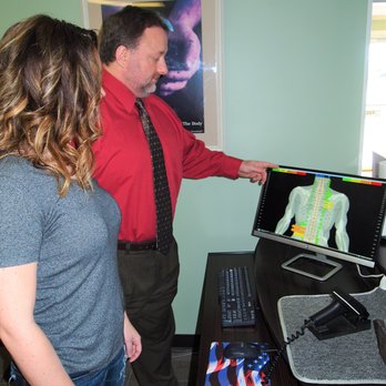 Anderson Upper Cervical - Dr. Patrick Anderson DC showing a patient her scan reading - Chiropractors Near Me - Dallas, Georgia Anderson Upper Cervical - Dr. Patrick Anderson DC showing a patient her scan reading - Chiropractors Near Me - Dallas, Georgia