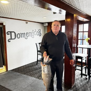 Domenico's On the Wharf - The owner, Sammy, holding fresh local Monterey Salmon - Seafood Near Me - Monterey, California Domenico's On the Wharf - The owner, Sammy, holding fresh local Monterey Salmon - Seafood Near Me - Monterey, California