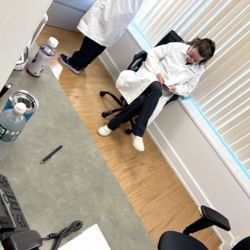 Labcorp - Staff worker sitting and playing on her phone while her coworker citing her own inability to find a file in their system.