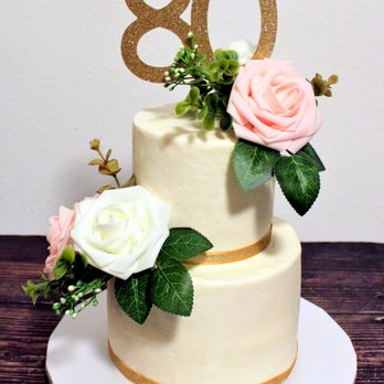 Katy's Kitchen - a three tiered cake with flowers on top - Desserts Near Me