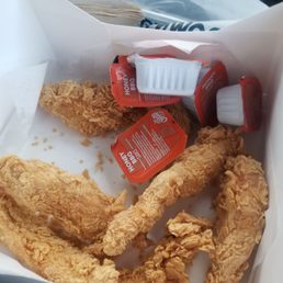 a close up of a basket of fried chicken