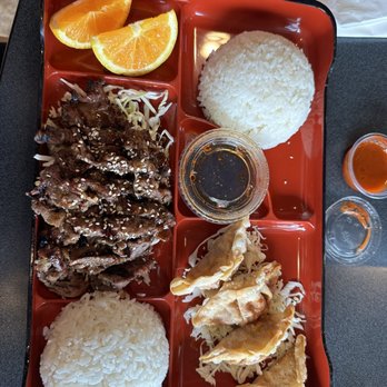 Sushi & Roll - a tray of food with rice, meat, and orange slices - Sushi Bars Near Me - Covina, California