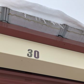 Dino's Storage - Ice and snow hanging off roof over unit door - Self Storage Near Me - Des Moines, Iowa
