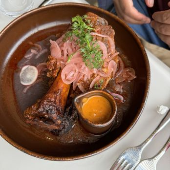 Paseo - MAMA'S COCHINITA PIBIL: guerrero-style pork shank, black bean pureé, pickled red onion, habanero salsa, corn tortillas - Mexican Near Me - Anaheim, California Paseo - MAMA'S COCHINITA PIBIL: guerrero-style pork shank, black bean pureé, pickled red onion, habanero salsa, corn tortillas - Mexican Near Me - Anaheim, California