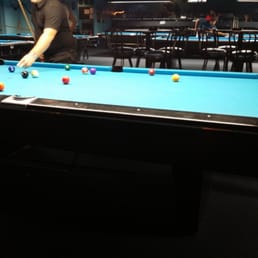 a man playing a game of pool a man playing a game of pool